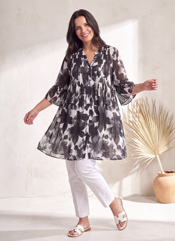 TEKOA — Black and white floral print tunic worn over white trousers, new markdown — Jean Marc Philippe